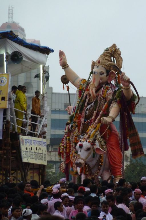 The police watch whilst Ganesh waves at the crowds