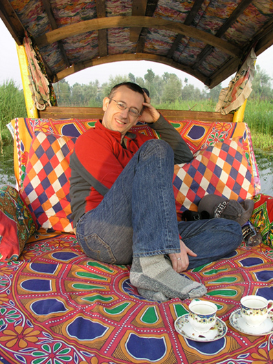 Maharaj Cope in the shikara drinking saffron-laced tea from a china cup
