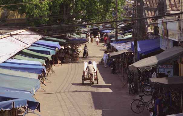 The iceman making his daily deliveries in much haste as he lacks a freezer in his vehicle!  Hoi An